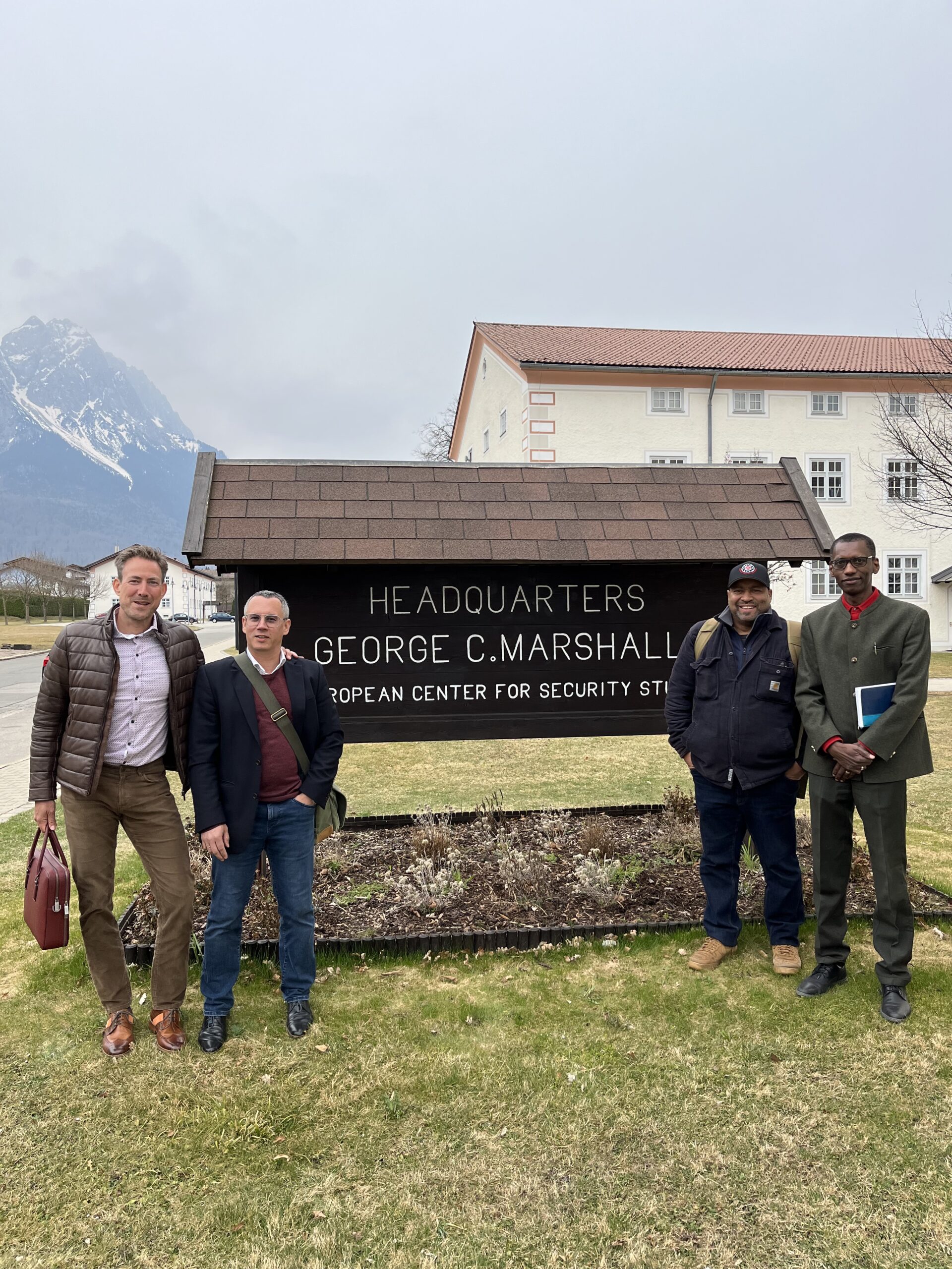 Matthias Duchscherer, Enrico Scharrenberg and John Kantara in front of the headquarter sign