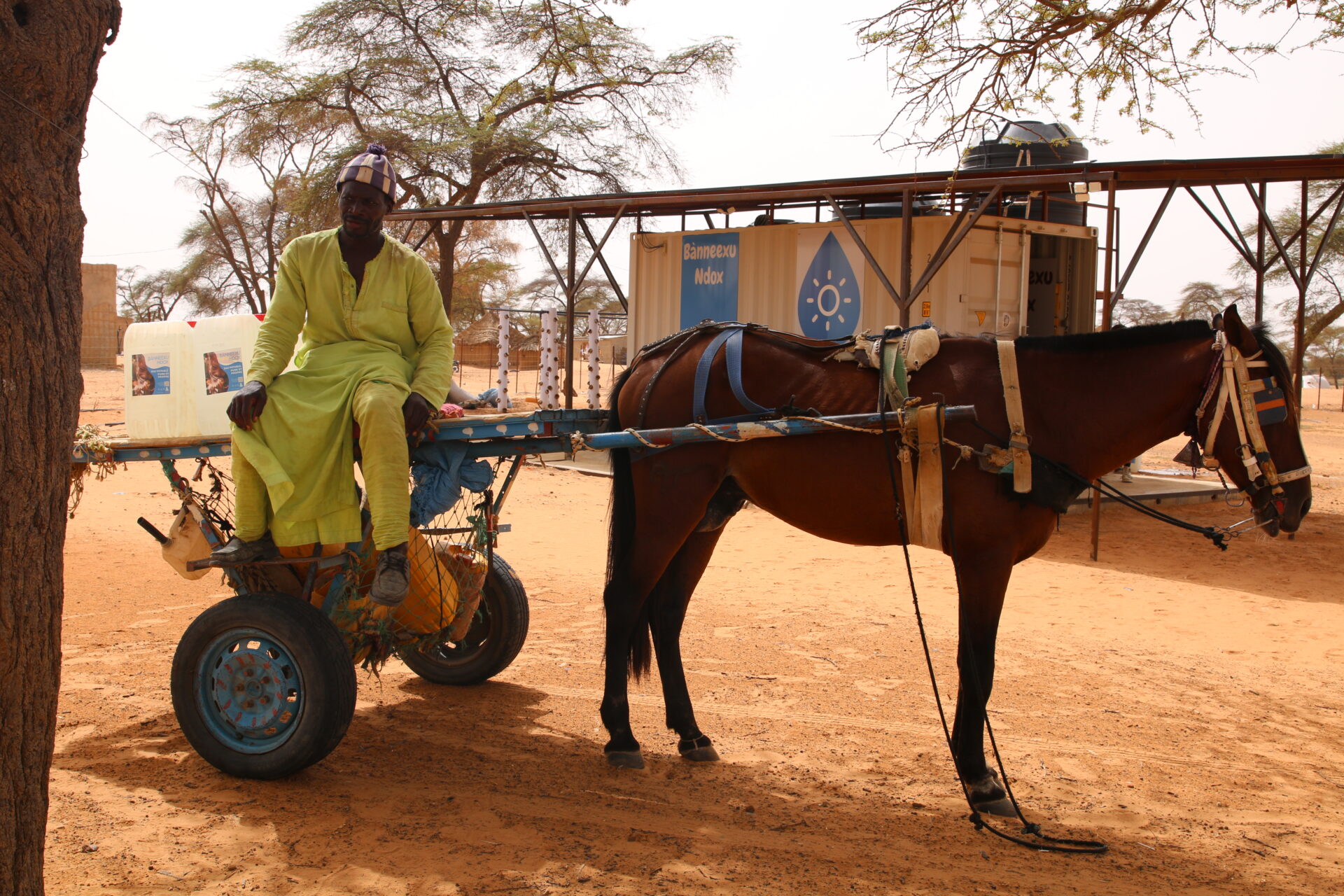 Horse cart and driver supplying water to communities from Water Desalination Kiosk in northern Senegal, called Banneexu Ndox